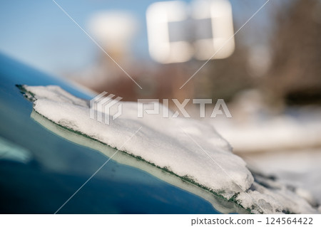 ice and snow on the front windshield of a vehicle. 124564422