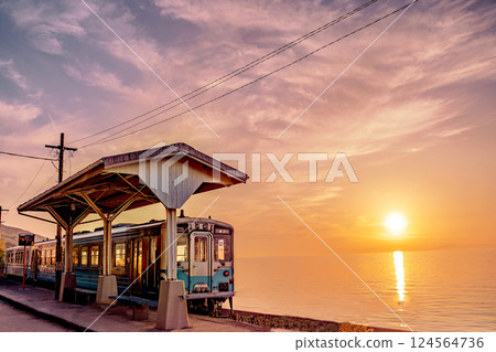 Sunset and train at a station near the sea 124564736