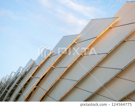 Arch of the football stadium. Part of a sports facility. Sports complex engineering. Complex design. Arch of the football stadium. Part of a sports facility. Sports complex engineering. Complex design. 124564775