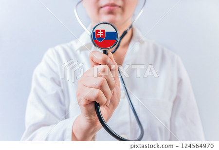 Female doctor holding stethoscope with Slovakian flag. National health system of Slovakia Female doctor holding stethoscope with Slovakian flag. National health system of Slovakia 124564970