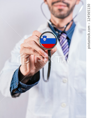 Slovenia health and medical insurance concept. Slovenia healthcare system, doctor holding stethoscope Slovenia health and medical insurance concept. Slovenia healthcare system, doctor holding stethoscope 124565130