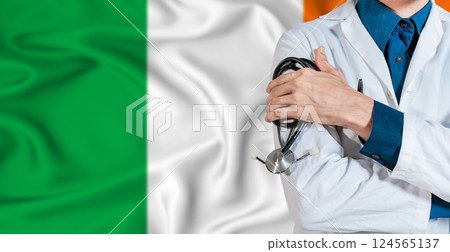 Doctor with stethoscope on Ireland flag. Doctor holding stethoscope on Ireland flag 124565137