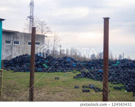 Mountains of fruit boxes. Lots of plastic boxes. Waste dump. Collecting plastic. 124565431