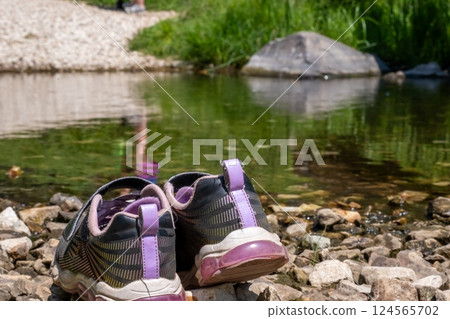 Selective focus a pair of shoes left on the bank of Spring Creek on the Sheridan Lake trail in the Black Hills of South Dakota. 124565702