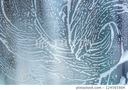 soap foam pattern wipe marks on window glass, window cleaning , blue background soap foam pattern wipe marks on window glass, window cleaning , blue background 124565984
