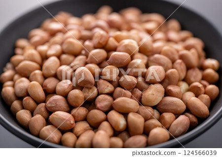 Raw peanuts in a bowl, representing natural nutrition and plant-based protein. Raw peanuts in a bowl, representing natural nutrition and plant-based protein. 124566039