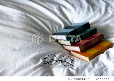 Comfortable bed and beautiful books 124566330