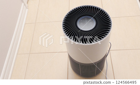 Close up view of Air Purifier with Black Fan. Black Round Electronic Device with Buttons and Bright Lights on White Background Close up view of Air Purifier with Black Fan. Black Round Electronic Device with Buttons and Bright Lights on White Background 124566495