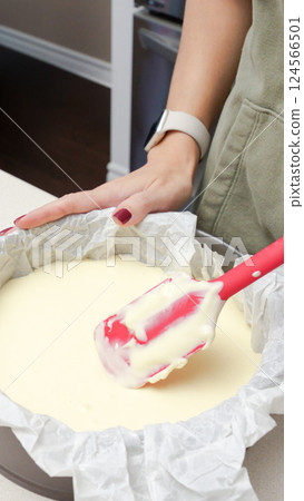 Deliciously Smooth Cake Batter Being Mixed with a Red Spatula in a Black Round Cake Pan Deliciously Smooth Cake Batter Being Mixed with a Red Spatula in a Black Round Cake Pan 124566501