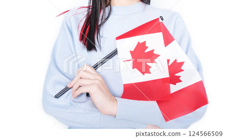 Unrecognized girl student in blue shirt holding small Canadian flag over gray background, Canada day, holiday, vote, immigration, tax, copy space Unrecognized girl student in blue shirt holding small Canadian flag over gray background, Canada day, holiday, vote, immigration, tax, copy space 124566509