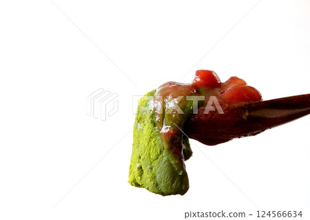 Melty matcha warabi mochi lifted with a wooden spoon Melty matcha warabi mochi lifted with a wooden spoon 124566634