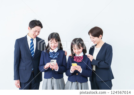 Girl using smartphone, parents watching 124567014