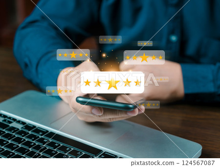 Online customer satisfaction survey service, The customer is hand-press on the smartphone with gold five-star rating feedback icon and pressing excellent rank to give the best score point for review 124567087