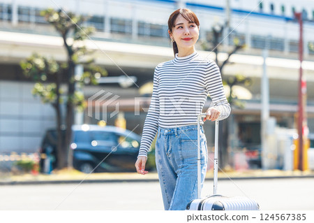A woman traveling and a bullet train A woman traveling and a bullet train 124567385