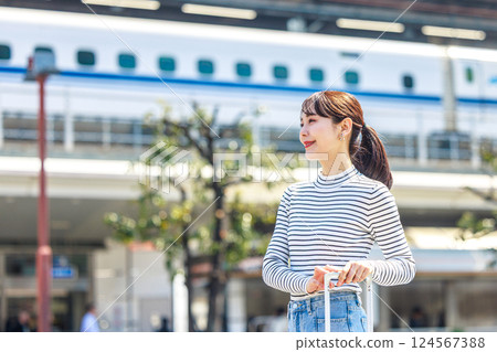 A woman traveling and a bullet train 124567388