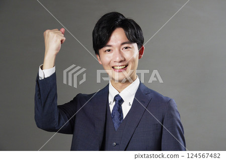 Businessman fist pump black background 124567482