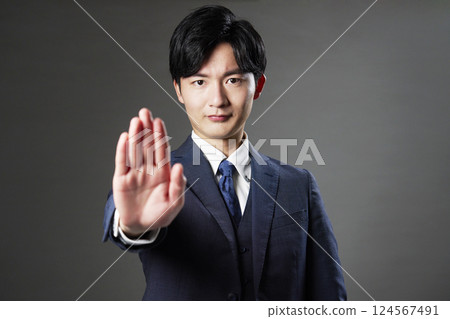 Businessman stop gesture black background 124567491