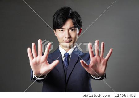 Businessman stop gesture black background 124567492