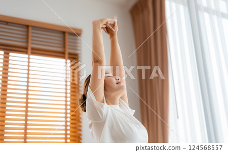 Young Asian beautiful woman doing stretch in the morning at home. Health care and body care concept 124568557