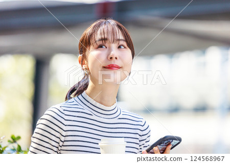 Woman looking at smartphone, meeting Woman looking at smartphone, meeting 124568967