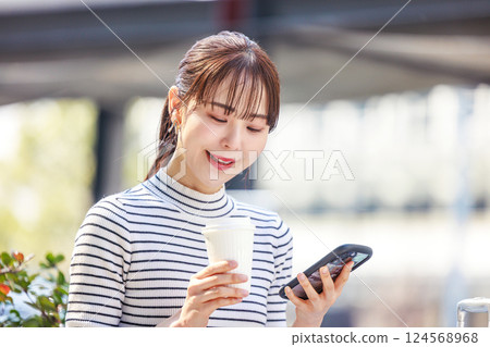 Woman looking at smartphone, meeting 124568968