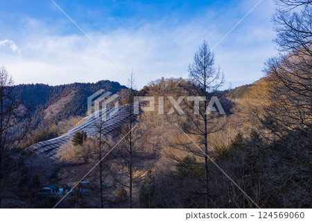 Solar panels visible on a winter mountainside 124569060