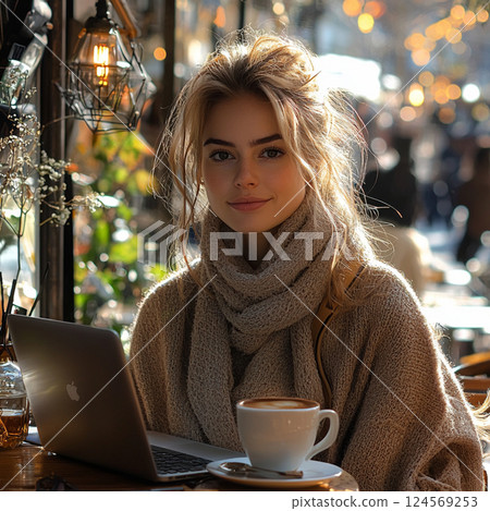 Woman Working on a Laptop in a Bright Café 124569253