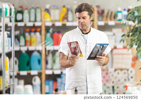 Adult man choosing razor in store Adult man choosing razor in store 124569850