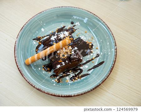 Piece of chocolate cake with chocolate topping 124569979