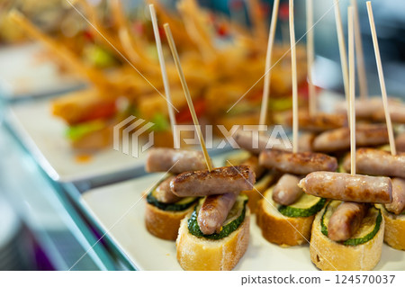 Pincho with sausages and cucumbers Pincho with sausages and cucumbers 124570037