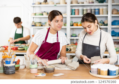 Two young women making pottery in workshop Two young women making pottery in workshop 124570160