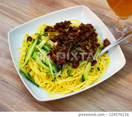 Portion of noodles, supplemented with thinly sliced fresh cucumbers and stewed minced meat. Portion of noodles, supplemented with thinly sliced fresh cucumbers and stewed minced meat. 124570216