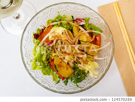 Japanese salad with tomatoes, cucumbers and onions closeup 124570289