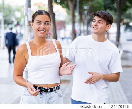 Charming young girl flirting with guy at street 124570316