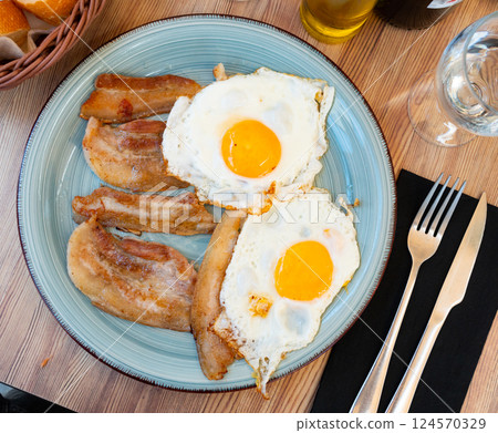 Hearty homemade breakfast - fried eggs with bacon, bread, coffee drink 124570329
