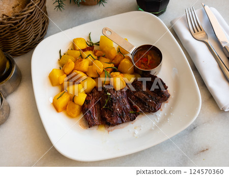 Fried beef fillet with potatoes and sauce Fried beef fillet with potatoes and sauce 124570360