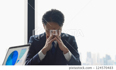 Business person worried in the office Business person worried in the office 124570483