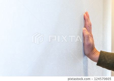 Place one hand on a white wall Place one hand on a white wall 124570605