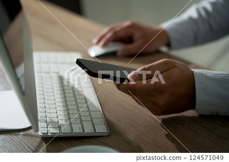 man holding en hands and using digital tablet Mobile Phone telephone with blank copy space scree 124571049