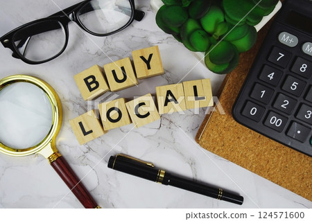 Buy Local with wooden blocks alphabet letters and Magnifying glass and calculator on marble background Buy Local with wooden blocks alphabet letters and Magnifying glass and calculator on marble background 124571600
