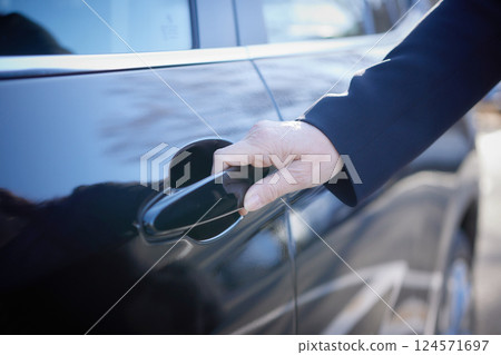 Middle-aged woman in a suit driving a car Middle-aged woman in a suit driving a car 124571697