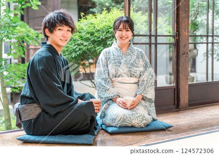 Asian couple in yukata sitting on the veranda of a Japanese house Asian couple in yukata sitting on the veranda of a Japanese house 124572306