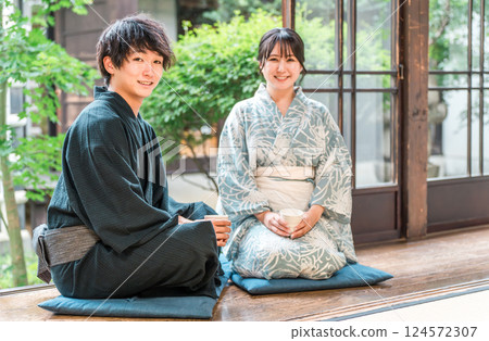 Asian couple in yukata sitting on the veranda of a Japanese house 124572307