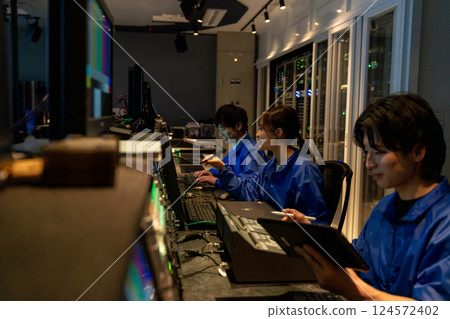 Staff working in a broadcasting station's control room Staff working in a broadcasting station's control room 124572402
