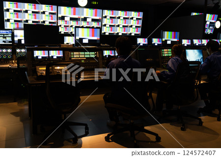 Staff working in a broadcasting station's control room Staff working in a broadcasting station's control room 124572407