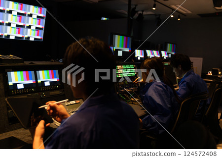 Staff working in a broadcasting station's control room Staff working in a broadcasting station's control room 124572408