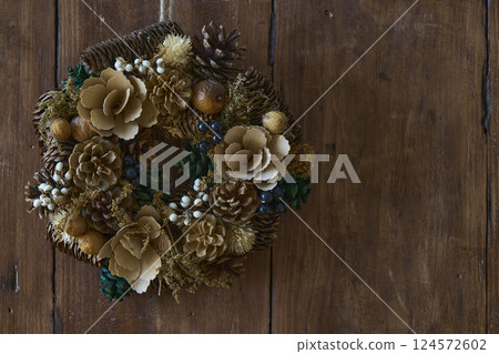 Christmas wreath on an antique wooden wall Christmas wreath on an antique wooden wall 124572602