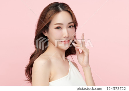 A beautiful young Asian woman with clean, fresh skin against a pink background. Skincare, facial treatment, cosmetology, beauty, and spa. An elegant portrait of an Asian woman. A beautiful young Asian woman with clean, fresh skin against a pink background. Skincare, facial treatment, cosmetology, beauty, and spa. An elegant portrait of an Asian woman. 124572722