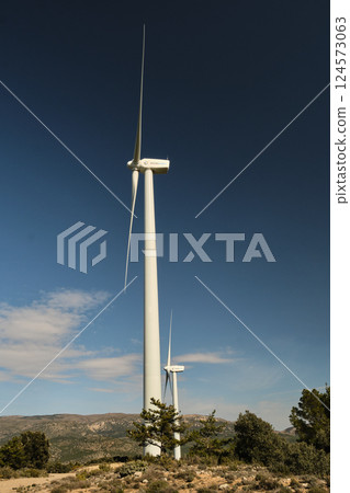 a wind turbine against the background of the blue sky 124573063