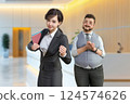 A male boss looks at a motivated office lady and has high expectations 124574626